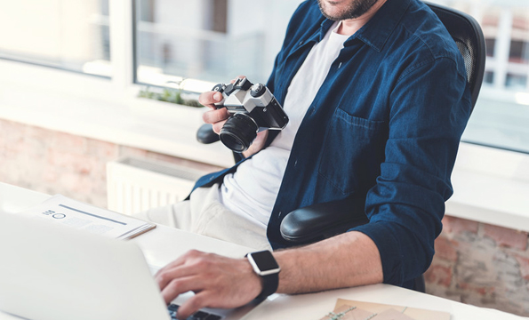 Guy on Laptop Holding Camera